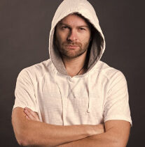 Man in a hoodie with arms crossed.