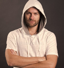 Man in a hoodie with arms crossed.